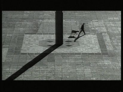 Ein Mann läuft an einer Säule vorbei, gefolgt von einem Schaf