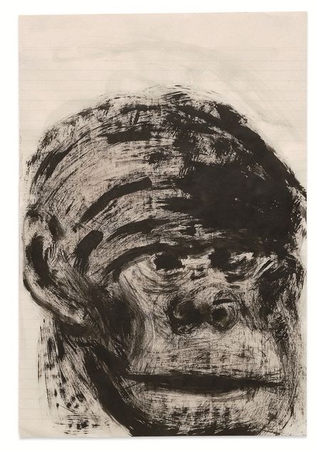A head sketched in black paint with rough brushstrokes, resembling that of a monkey