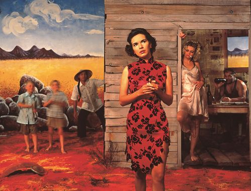 A young woman in a red dress with black roses printed on it stands in front of a dilapidated rural hut. She looks into the distance. The surroundings are dry and barren. Other figures can be seen in the background, including children, a woman in a nightgown and a man sitting at a table drinking from a bottle.