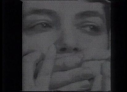 Nine square black and white pictures on black background. All of them show in slightly different representation the same woman, who has her mouth held shut by strange hands, as she tries to free herself from it with her own hands. 