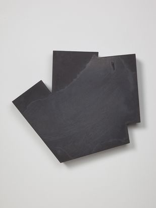 Dreidimensionales schwarzes Wandobjekt mit unregelmäßigem Umriss.