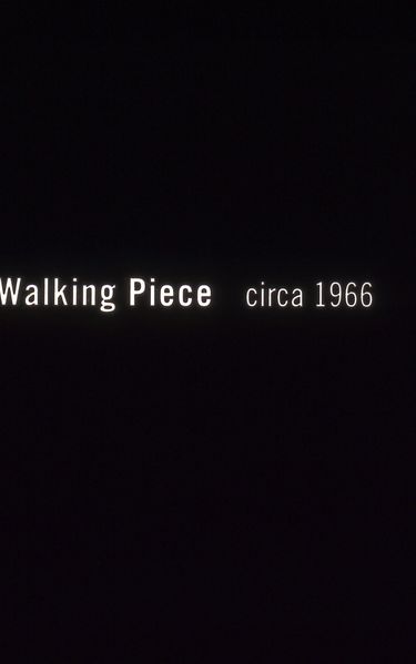White lettering on a black background: “Walking Piece circa 1966”.